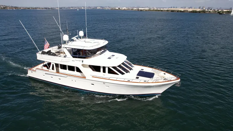 Slide: The Image of 2005 Offshore Yachts 72' cruising on open water, showcasing elegant design and spacious deck. - 32