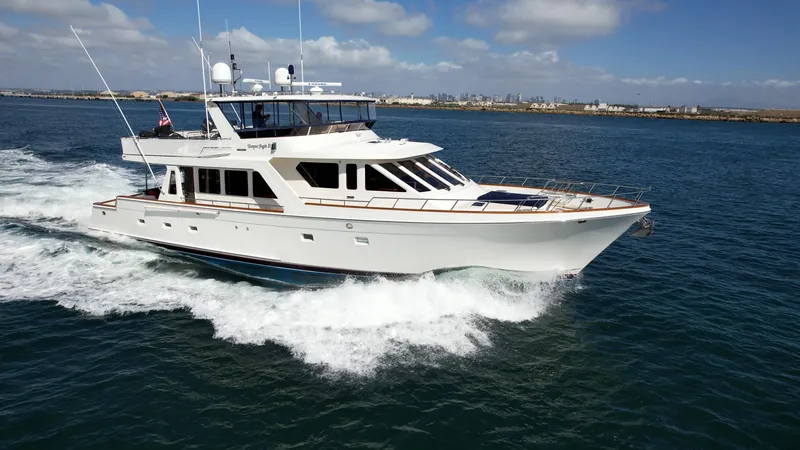 Slide: The Image of 2005 Offshore Yachts 72' cruising on open water under a clear sky. - 33
