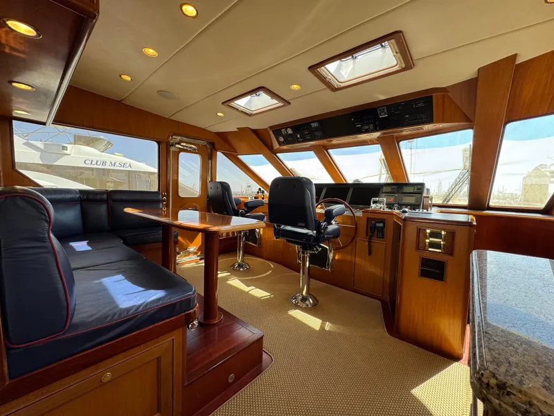 Slide: The Image of Luxurious 2005 Offshore Yachts 72' interior with plush seating and modern navigation equipment. - 7
