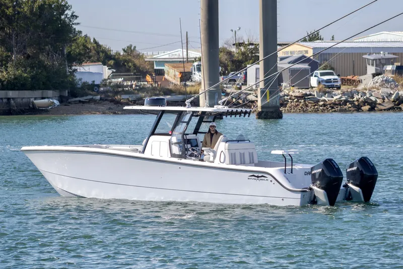 Slide: The Image of 2022 Invincible 33 Catamaran cruising on water with dual outboard engines. - 5