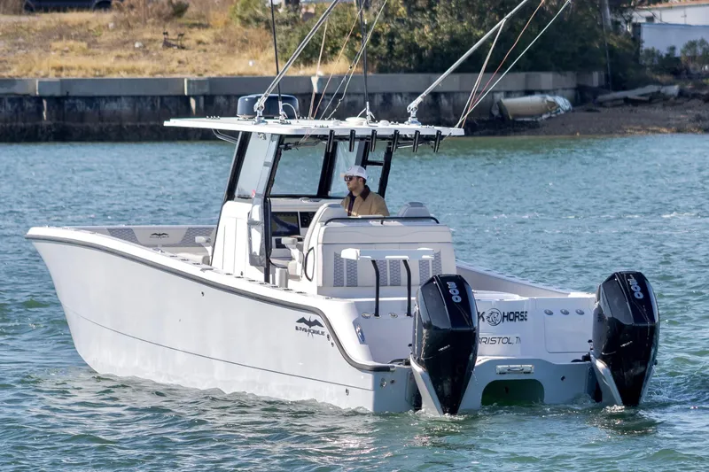 Slide: The Image of 2022 Invincible 33 Catamaran on water, dual outboard motors, sleek design. - 6