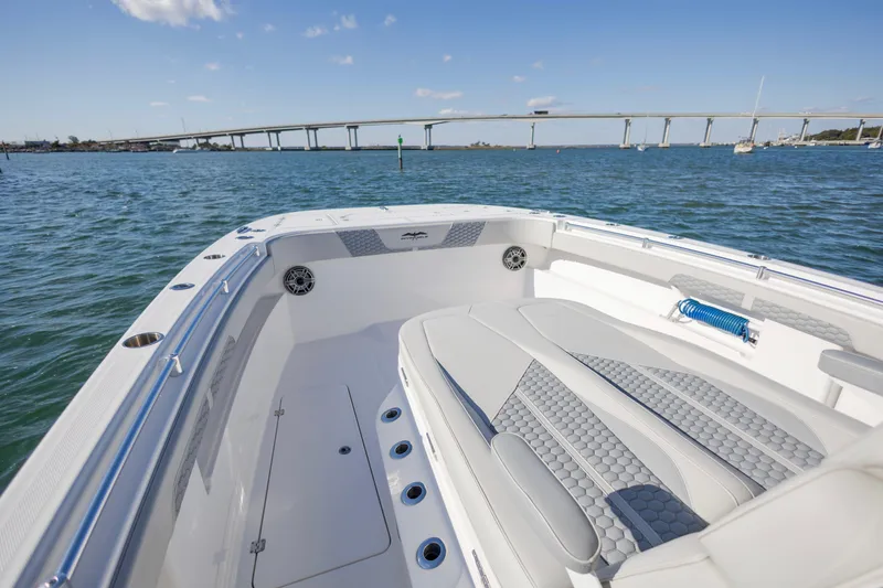 Slide: The Image of 2022 Invincible 33 Catamaran on water, bridge in background, sunny day. - 8