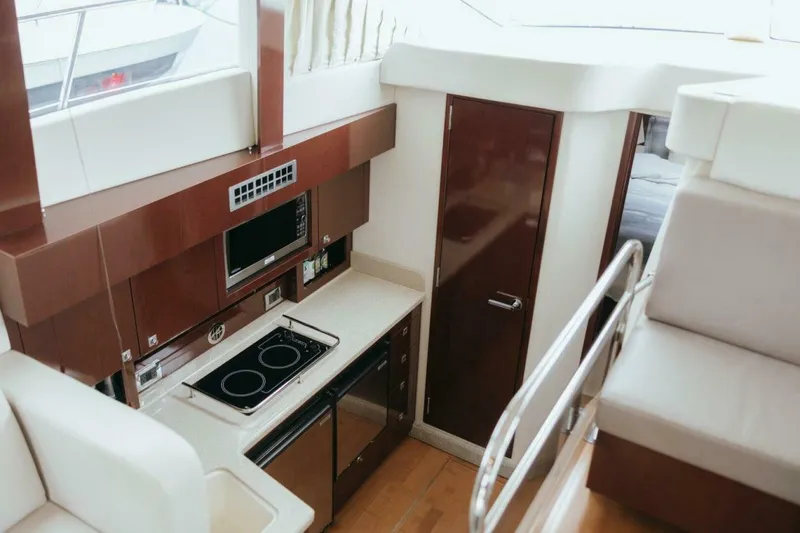Slide: The Image of Interior of 2010 Sea Ray 390 Sedan Bridge yacht with modern kitchen amenities. - 10