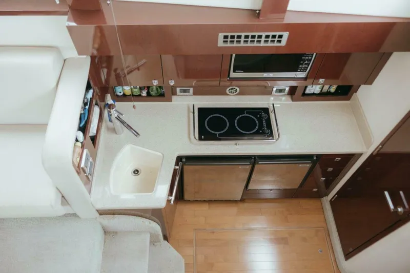 Slide: The Image of Modern kitchen in 2010 Sea Ray 390 Sedan Bridge yacht with stove, sink, and microwave. - 11