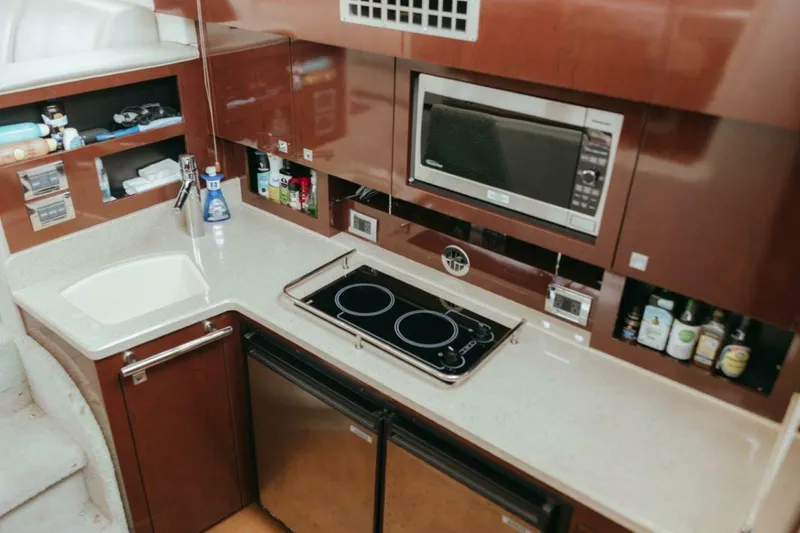 Slide: The Image of Modern kitchen in 2010 Sea Ray 390 Sedan Bridge yacht with stove, microwave, and sink. - 13