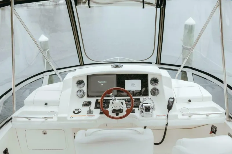 Slide: The Image of 2010 Sea Ray 390 Sedan Bridge helm with modern controls and navigation system. - 15