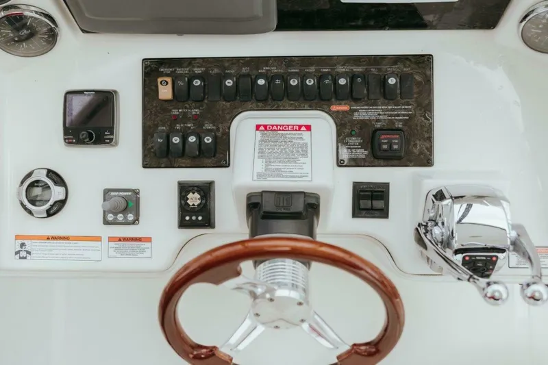Slide: The Image of Control panel of 2010 Sea Ray 390 Sedan Bridge with steering wheel and navigation instruments. - 17