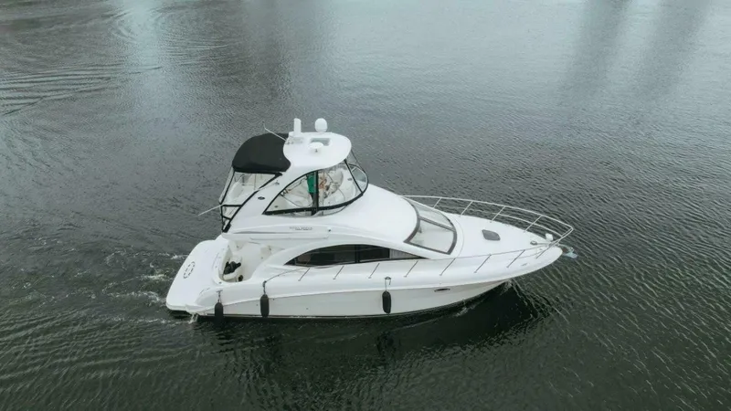 Slide: The Image of 2010 Sea Ray 390 Sedan Bridge yacht cruising on calm waters. - 22