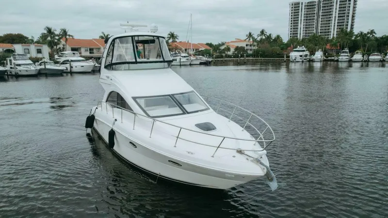 Slide: The Image of 2010 Sea Ray 390 Sedan Bridge yacht on calm water near marina. - 24