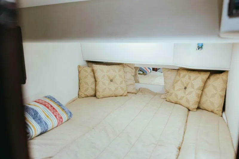 Slide: The Image of Cozy cabin interior of 2010 Sea Ray 390 Sedan Bridge with decorative pillows. - 5