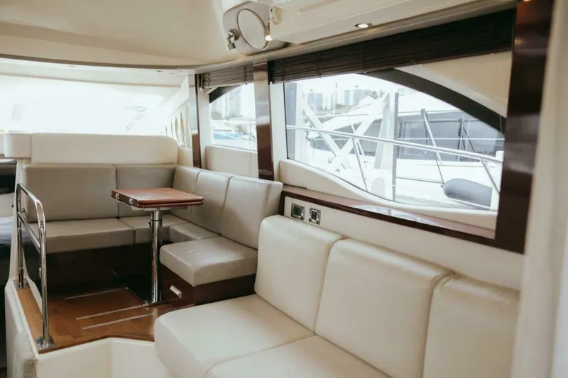 Slide: The Image of Luxurious interior of 2010 Sea Ray 390 Sedan Bridge yacht with plush seating and elegant design. - 8