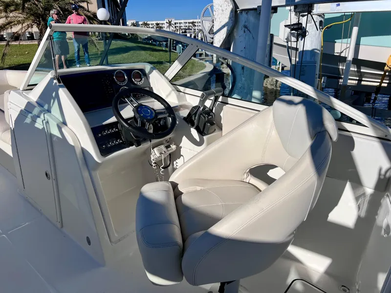 Slide: The Image of 2015 Carolina Cat 23 SD boat interior with steering wheel and captain's chair. - 12