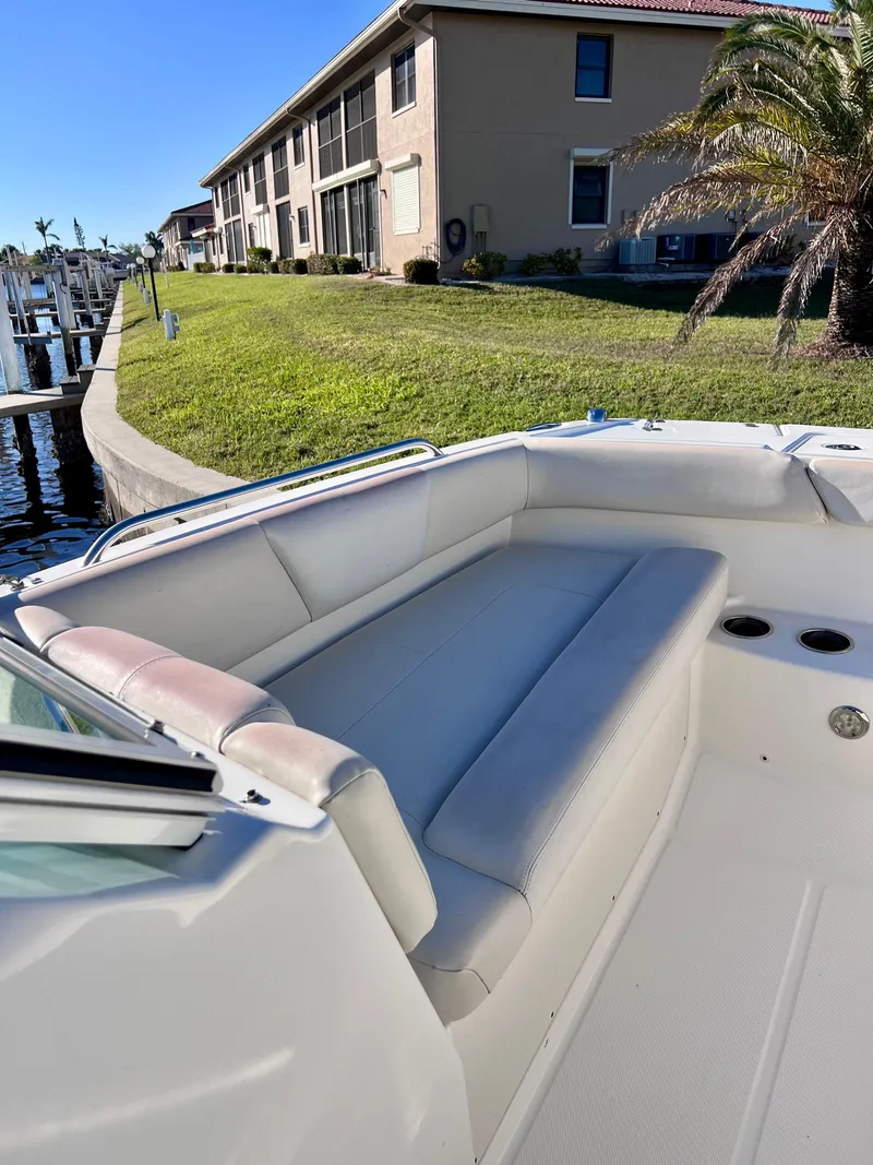 Slide: The Image of 2015 Carolina Cat 23 SD boat interior with seating, docked near waterfront homes. - 19