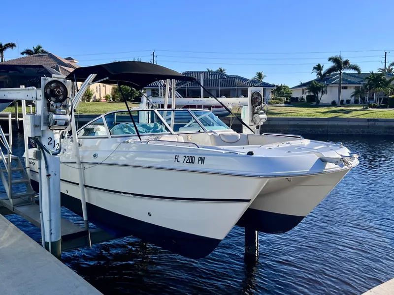 Slide: The Image of 2015 Carolina Cat 23 SD boat docked on a sunny day. - 2