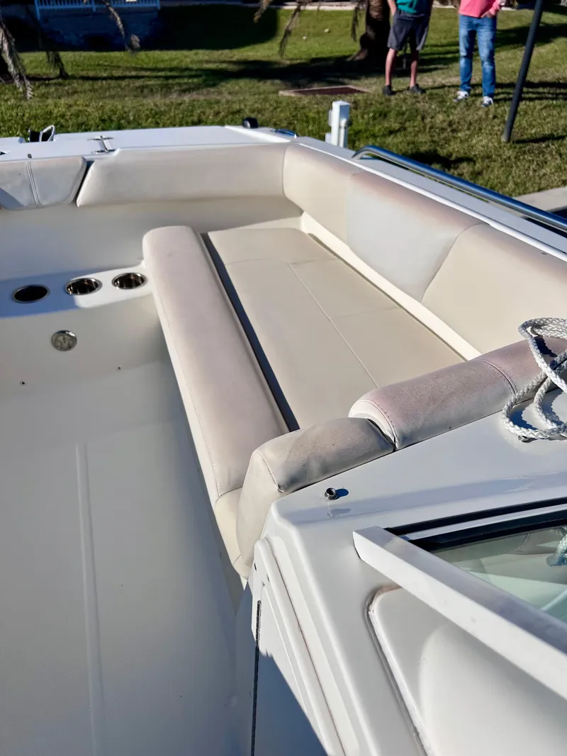 Slide: The Image of 2015 Carolina Cat 23 SD boat interior with cushioned seating and cup holders. - 20
