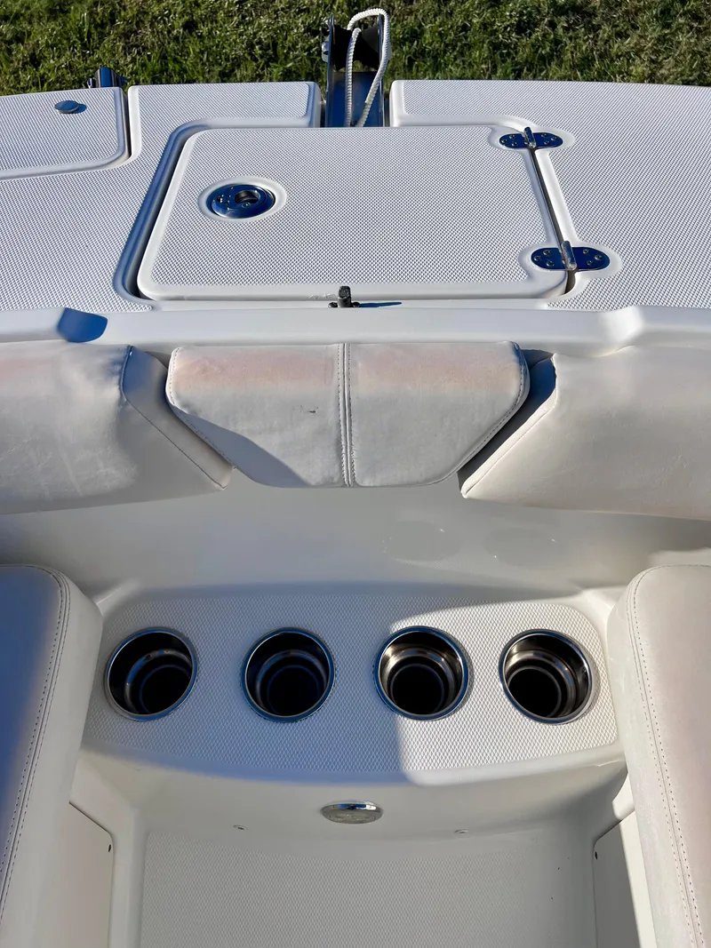 Slide: The Image of 2015 Carolina Cat 23 SD boat interior with cup holders and storage compartments. - 21