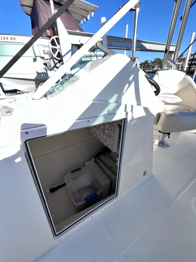 Slide: The Image of 2015 Carolina Cat 23 SD boat interior with open storage compartment. - 26