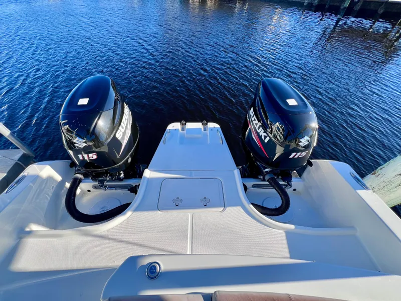 Slide: The Image of 2015 Carolina Cat 23 SD boat with twin Suzuki 115 outboard motors on water. - 5