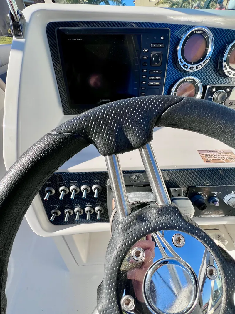 Slide: The Image of Close-up of 2015 Carolina Cat 23 SD boat dashboard with steering wheel and controls. - 8