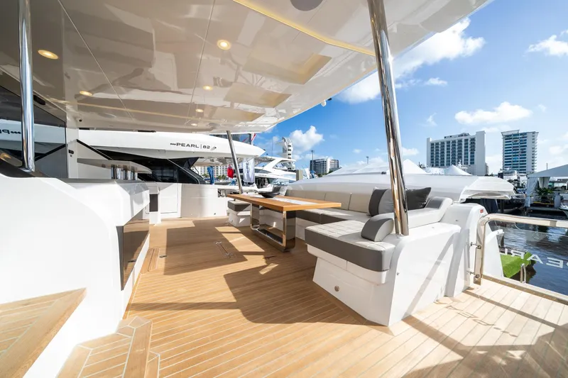 Slide: The Image of Luxurious Pearl 95 yacht deck, 2025 model, featuring elegant seating and modern design. - 18