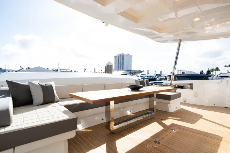 Slide: The Image of Luxurious Pearl 95 yacht deck with modern seating and table, 2025 model. - 21