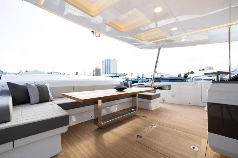 Slide: The Image of Luxurious Pearl 95 yacht deck with modern seating and wooden table, 2025 model. - 22