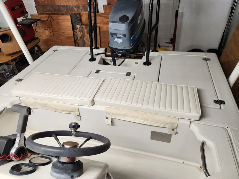 Slide: The Image of 1998 Hewes Bayfisher boat interior with steering wheel and Yamaha outboard motor. - 3