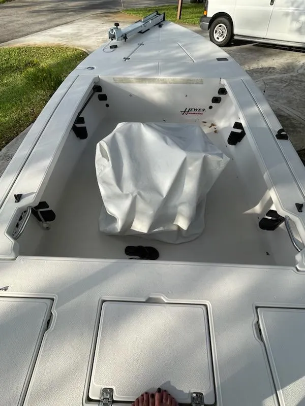 Slide: The Image of 1998 Hewes Bayfisher boat interior with storage compartments and cover. - 6