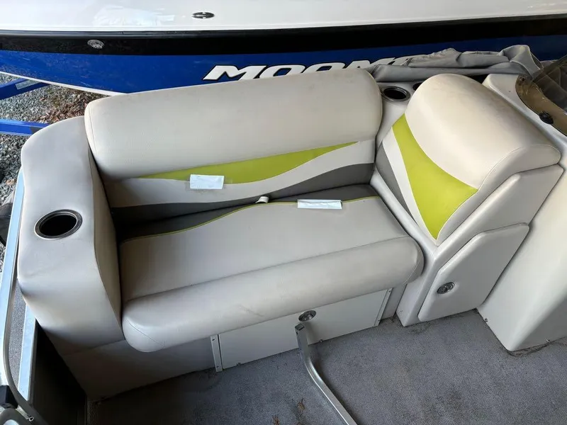 Slide: The Image of 2015 Apex Marine Qwest Adventure 820 Sport Cruise boat seating with cup holders and green accents. - 11