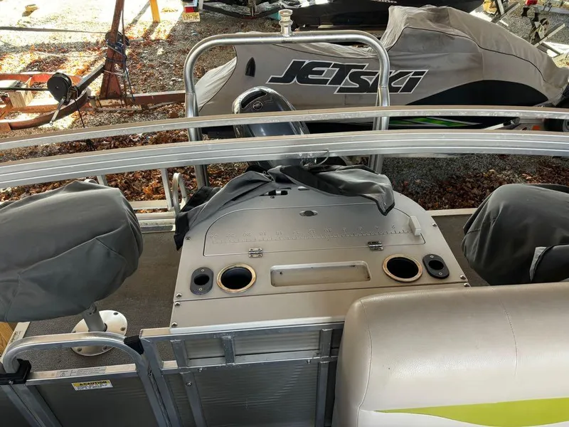 Slide: The Image of 2015 Apex Marine Qwest Adventure 820 Sport Cruise Adv interior with covered seats and control panel. - 12