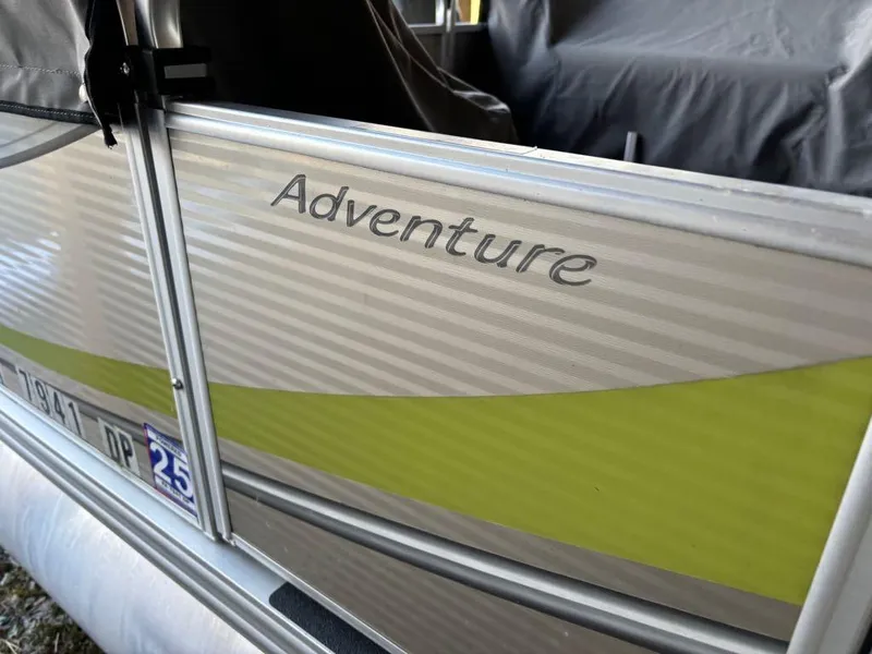 Slide: The Image of 2015 Apex Marine Qwest Adventure 820 Sport Cruise boat with "Adventure" branding. - 14