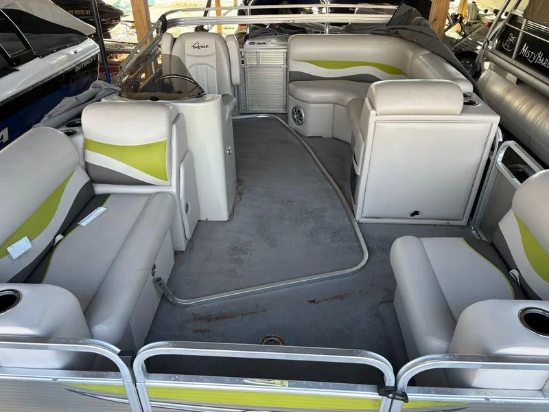 Slide: The Image of 2015 Apex Marine Qwest Adventure 820 Sport Cruise Adv interior with gray and green seating. - 15