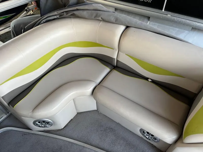 Slide: The Image of 2015 Apex Marine Qwest Adventure 820 Sport Cruise Adv boat seating with green accents. - 3