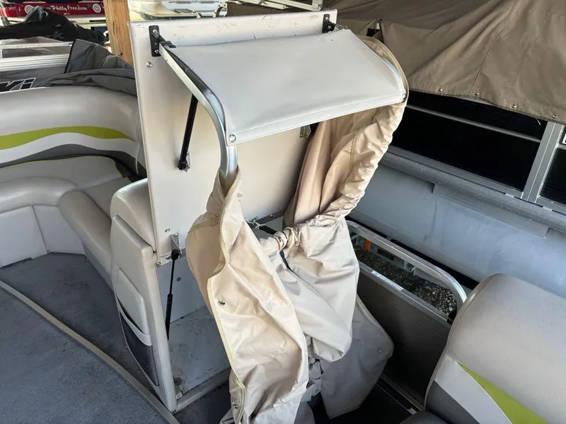 Slide: The Image of 2015 Apex Marine Qwest Adventure 820 Sport Cruise interior with beige seating and canopy. - 5