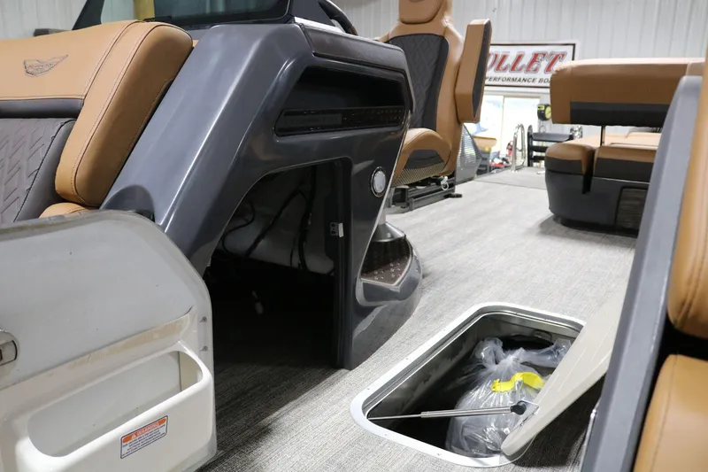 Slide: The Image of 2025 Bennington 22 M Swingback interior with storage compartments and seating. - 10