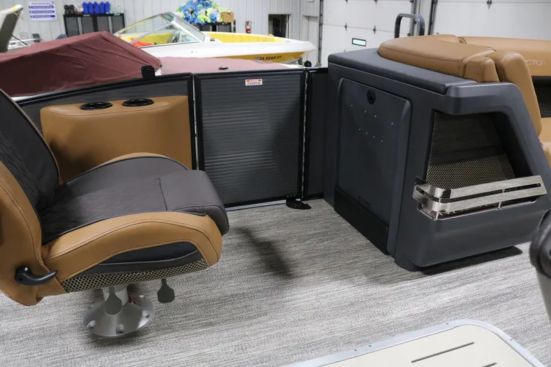 Slide: The Image of 2025 Bennington 22 M Swingback interior with tan and black seating, modern design. - 12