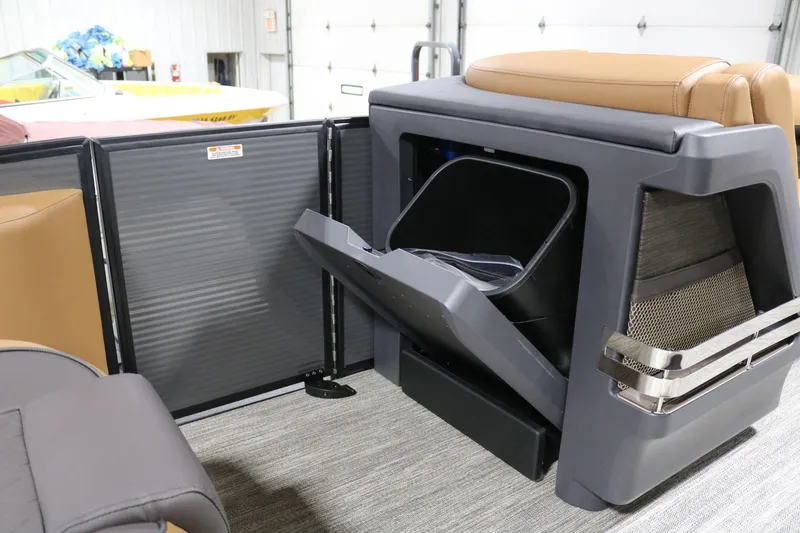Slide: The Image of 2025 Bennington 22 M Swingback interior with storage compartment open. - 13