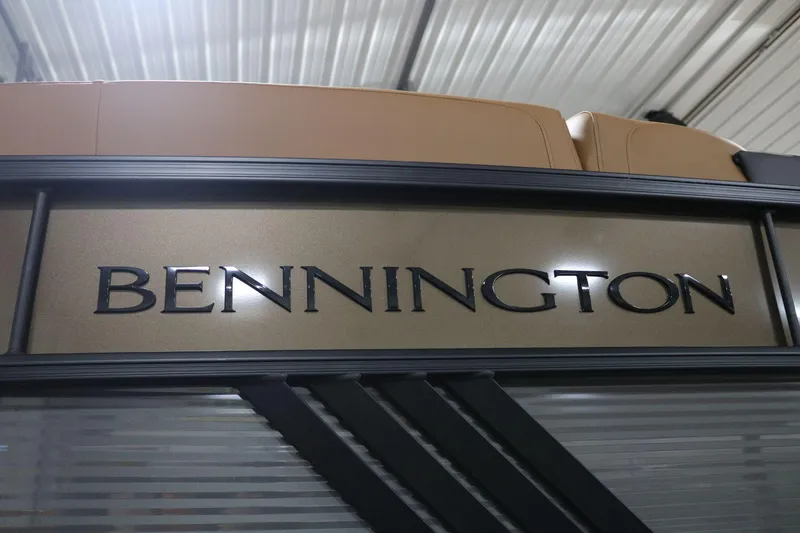 Slide: The Image of 2025 Bennington 22 M Swingback boat logo in a showroom setting. - 4