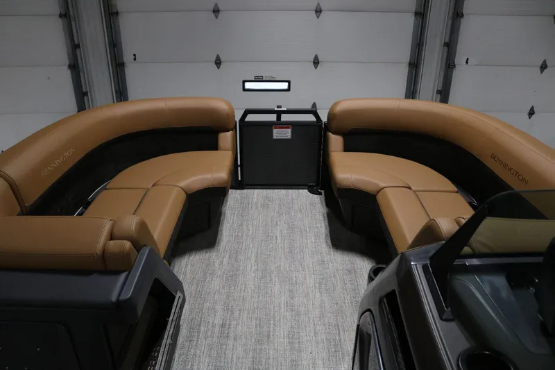 Slide: The Image of 2025 Bennington 22 M Swingback interior with tan seating and modern design. - 6