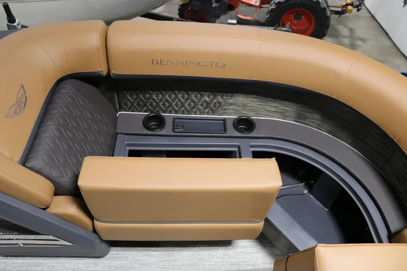 Slide: The Image of 2025 Bennington 22 M Swingback boat interior with tan seating and cup holders. - 7