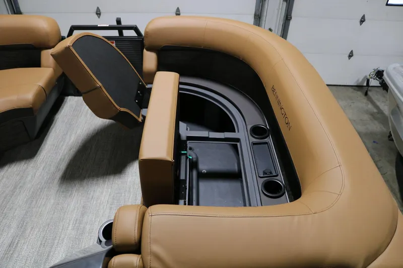 Slide: The Image of 2025 Bennington 22 M Swingback boat interior with tan seating and storage compartments. - 8