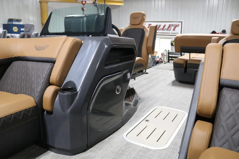 Slide: The Image of 2025 Bennington 22 M Swingback interior with luxurious tan and gray seating. - 9