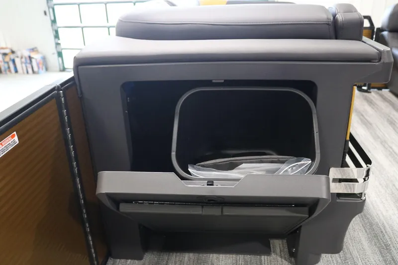 Slide: The Image of 2025 Bennington 22 M FASTBACK storage compartment with open lid, showcasing interior space. - 14