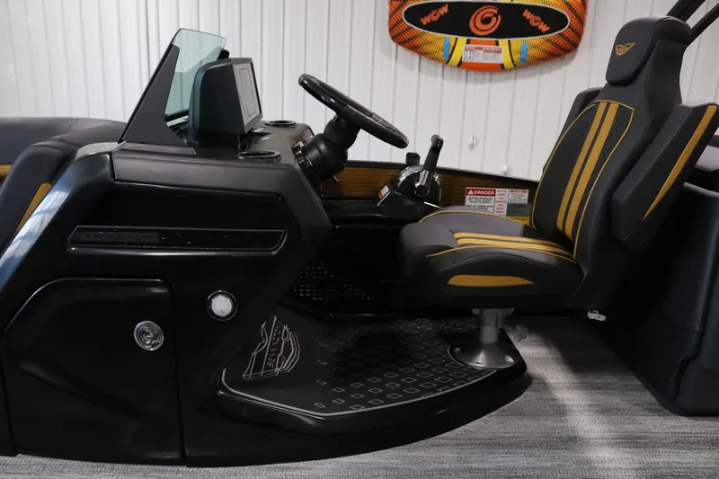 Slide: The Image of 2025 Bennington 22 M FASTBACK boat interior with sleek black and yellow captain's chair. - 16