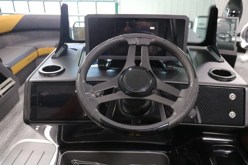 Slide: The Image of 2025 Bennington 22 M FASTBACK steering wheel and dashboard interior view. - 18