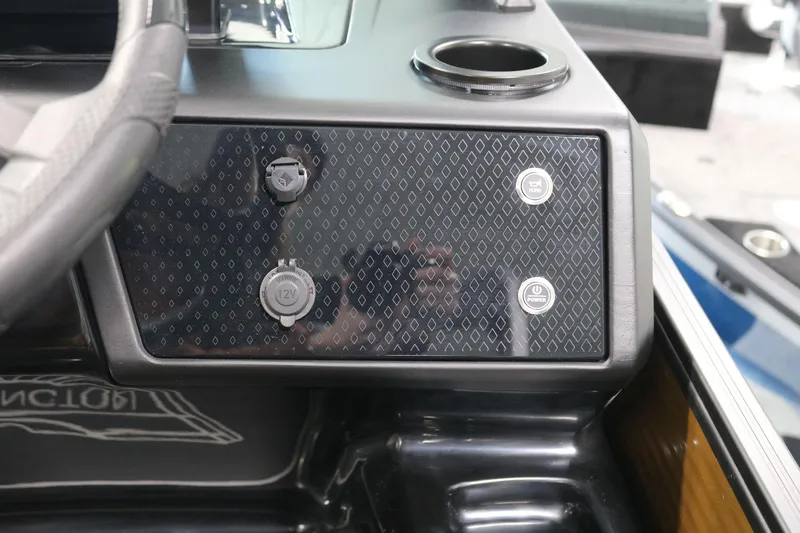 Slide: The Image of Dashboard of 2025 Bennington 22 M FASTBACK with control buttons and cup holder. - 21