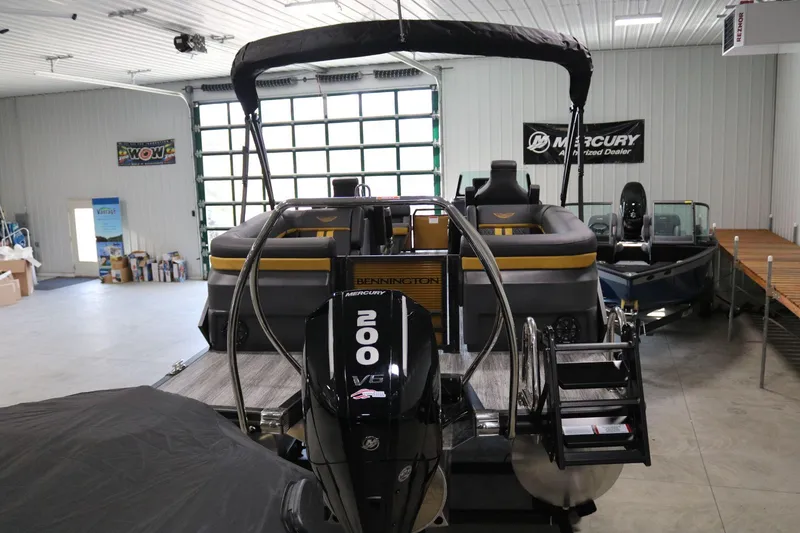 Slide: The Image of 2025 Bennington 22 M FASTBACK boat with Mercury 200 V6 engine in showroom. - 4