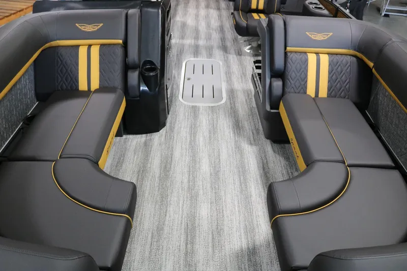 Slide: The Image of 2025 Bennington 22 M FASTBACK interior with sleek black and yellow seating. - 6