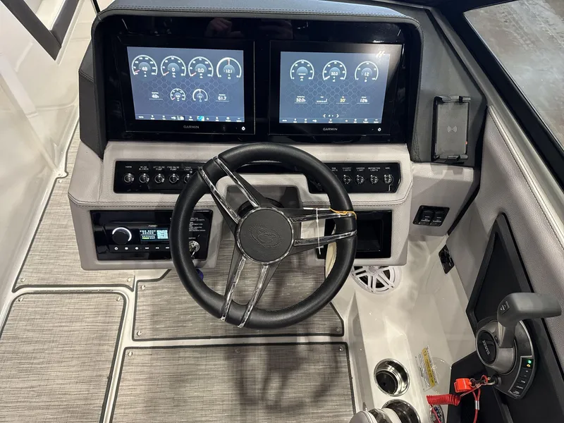 Slide: The Image of 2024 Cobalt R4 Surf boat dashboard with dual Garmin displays and modern controls. - 11