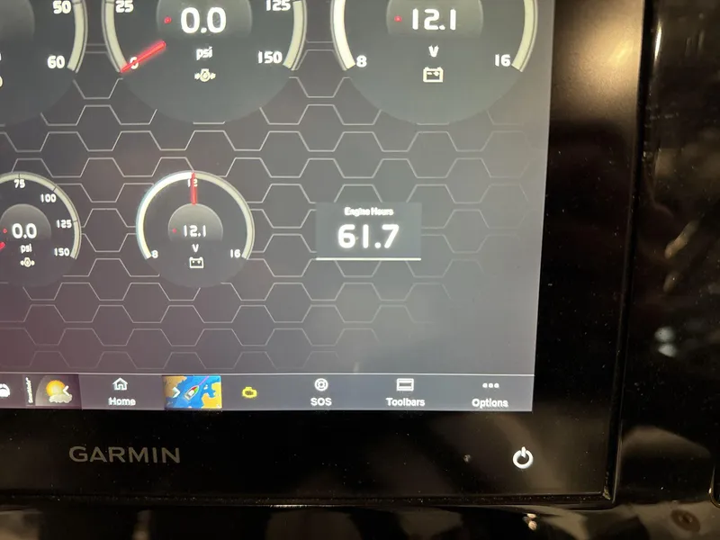 Slide: The Image of Garmin display showing engine metrics on 2024 Cobalt R4 Surf boat. - 17